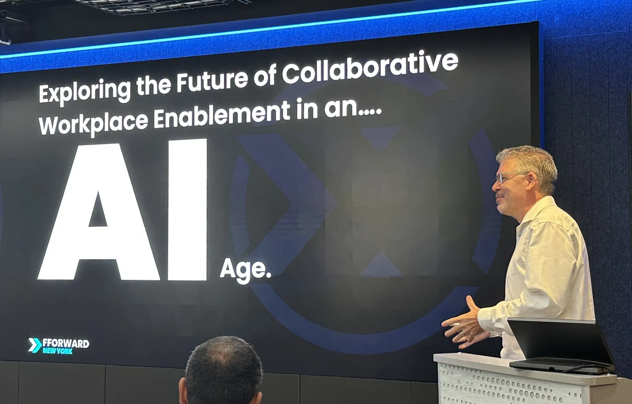 Byron speaking at FForward New York beside a presentation on the future of collaborative workplace enablement in the AI age